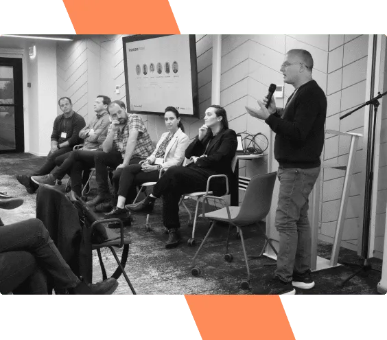 A black-and-white photo of a mentor panel taking questions at a past VentureHack