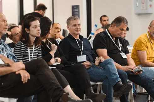 The front row of the audience listening to a pitch